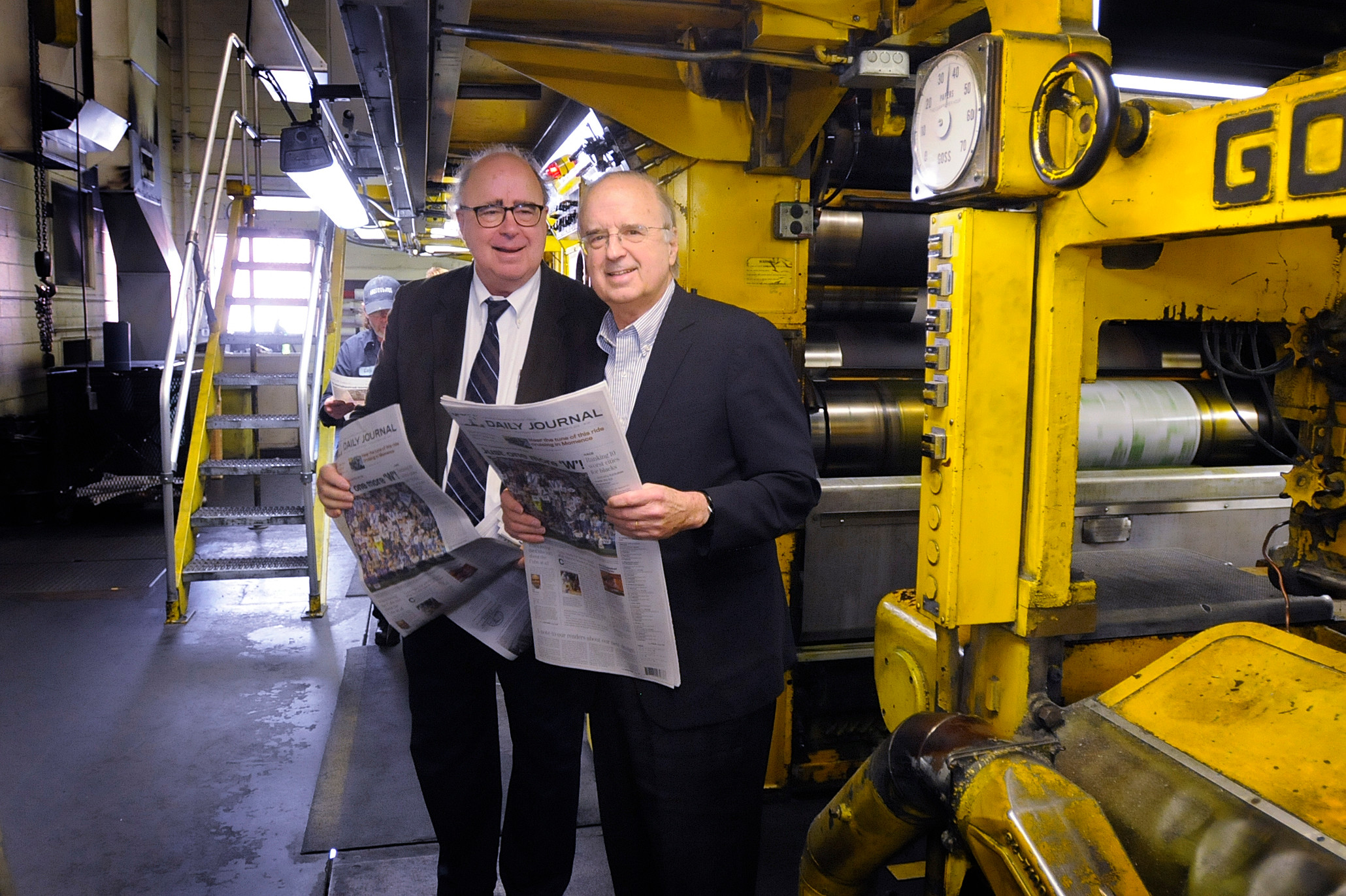Tom and Rob Small get their first look at the redesign of the (Kankakee, Ill.) Daily Journal in the press room of launch day.